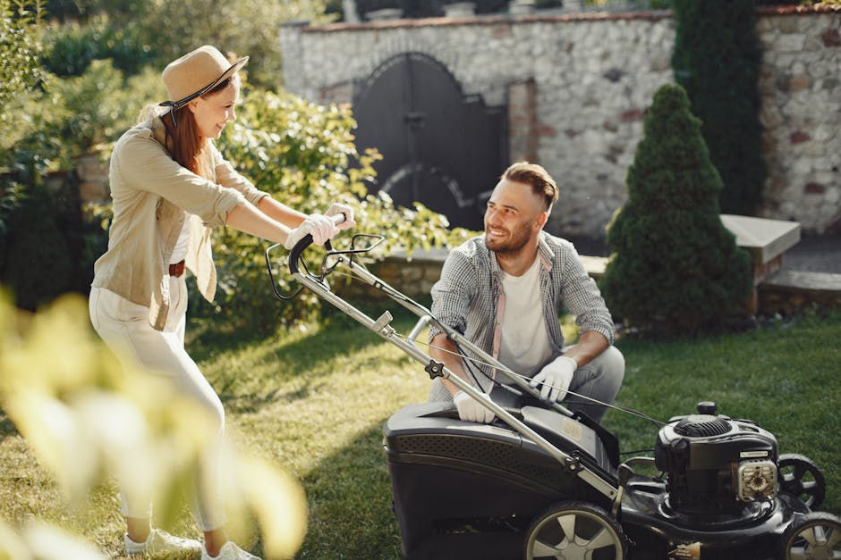 A cheerful couple working together in a garden with a lawn mower.